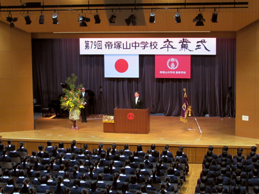 講堂で校長の話を聞く中学3年卒業生達