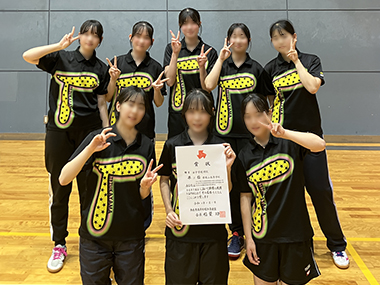 賞状を持ったりピースしてポーズする女子生徒8名