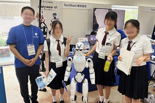 白いロボットと一緒に女子生徒3人とTechShareの方で記念撮影